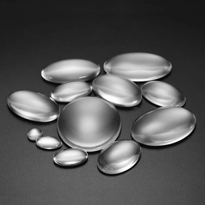 Clear oval glass cabochon tiles for DIY jewelry making set on grey background