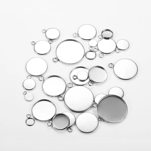 Flat lay of multiple stainless steel round pendant tray settings for DIY jewelry making