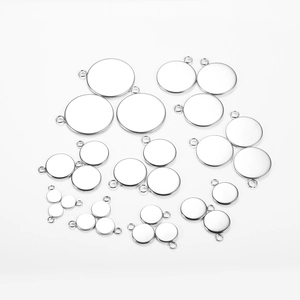 Macro view of stainless steel round tray pendants for DIY jewelry making in various sizes
