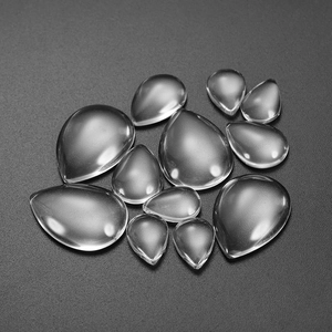 Macro view of transparent teardrop glass cabochons in various sizes for DIY jewelry
