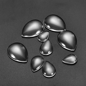 Macro shot of assorted sizes of transparent teardrop glass cabochons for DIY jewelry