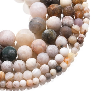 Macro shot of natural agate and quartz round beads in various sizes and earth tones