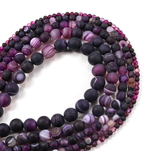 Macro view of matte grey striped agate loose beads in assorted sizes for jewelry making