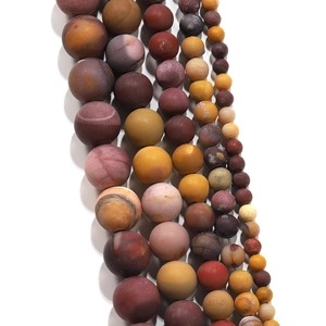 Macro detail of matte Mookaite natural stone beads in various sizes for DIY jewelry
