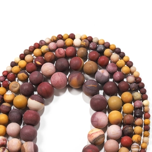 Macro shot of matte Mookaite Jasper round loose beads in various sizes for DIY jewelry