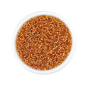 Macro shot of 2mm amber glass bugle beads for DIY jewelry in a round container