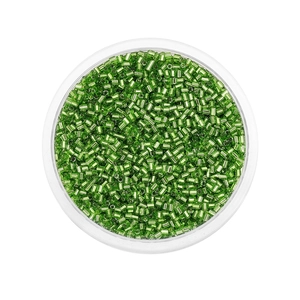 Macro shot of 2mm emerald green glass bugle beads in a transparent container for DIY jewelry