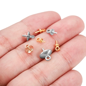 DIY jewelry parts featuring threaded eye pins for pearl pendants in gold and silver