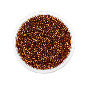 Macro shot of 2mm amber glass bugle beads for jewelry making in a plastic container