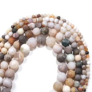Macro detail of frosted agate beads in earthy tones for DIY jewelry making