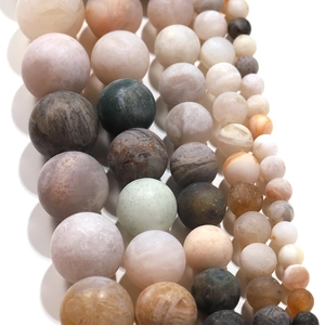 Detailed close-up of frosted bamboo leaf agate round beads showing natural textures
