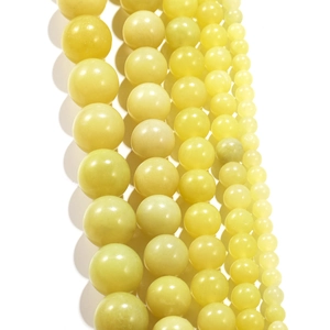 Detailed view of polished natural lemon jade round beads in multiple DIY sizes