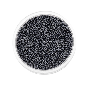 Detailed macro view of 2mm dark grey metallic glass seed beads in a clear container