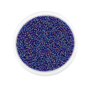 Macro view of 2mm iridescent glass seed beads in deep blue and purple with metallic finish