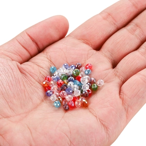 Handheld assorted faceted glass crystal beads in vibrant colors for DIY jewelry making