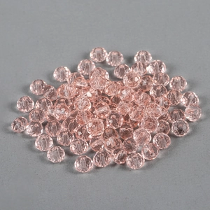 Detailed view of faceted light pink glass crystal beads for DIY jewelry making and crafts