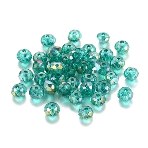 Faceted turquoise crystal spacer beads for DIY jewelry making on white background
