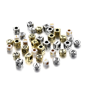 Mixed acrylic letter beads in cube and round shapes with gold, silver, and white finishes