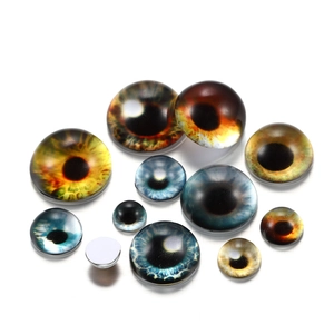 Close-up of assorted glass cat eye cabochons for DIY jewelry making and doll crafts