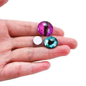 Close-up of glass evil eye dome cabochons in purple and blue for DIY jewelry