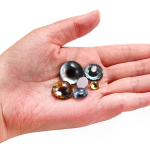 Macro shot of colorful glass dragon eye cabochons for jewelry making and doll DIY