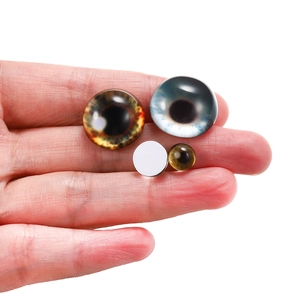 Detailed comparison of various sizes of glass cat eye cabochons for DIY jewelry making