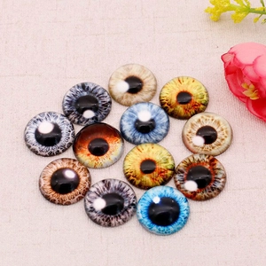 Flat lay of colorful 12mm glass cat eye cabochons for DIY jewelry and crafts