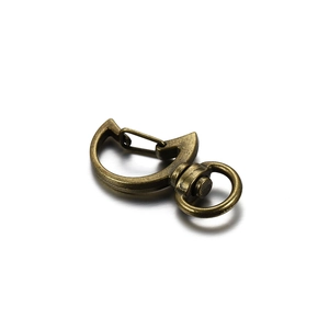 Macro detail of crescent moon swivel clasp in antique bronze finish with 360-degree rotation