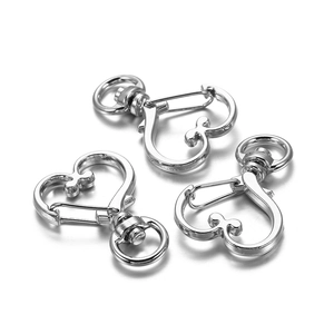 Three silver heart-shaped lobster clasps with rotating rings for DIY jewelry projects