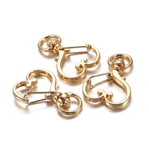 Three gold heart-shaped lobster clasps for DIY jewelry with rotating rings and shiny finish