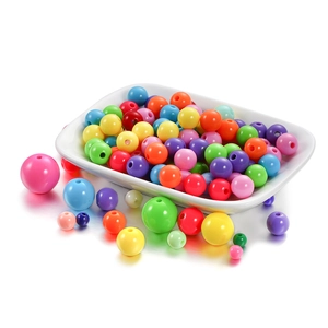 Mixed colorful acrylic 6mm spacer beads in a white ceramic dish for DIY jewelry making