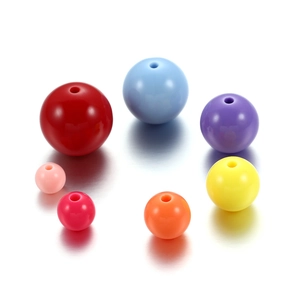 Macro shot of 6mm colorful acrylic round beads for DIY jewelry making in vibrant mixed colors