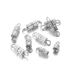 Macro detail of silver screw barrel clasps with knurled texture for jewelry making