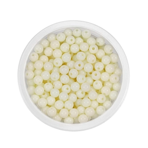 Macro detail of 6mm cream acrylic round beads with holes for DIY jewelry making