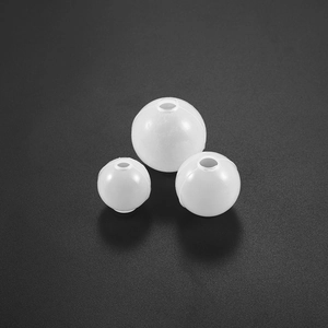 Three sizes of matte white translucent round DIY beads with center holes on grey background