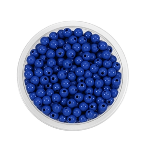 Top view of smooth dark blue acrylic round beads with center holes in a clear tray