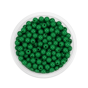 Top view of 6mm grass green acrylic spacer beads in a clear round plastic storage box