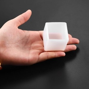 Translucent silicone cube mold held in hand for DIY crystal resin or candle making