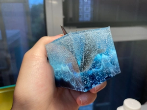 Detailed view of shark fin resin art cube with blue sea gradient and air bubbles