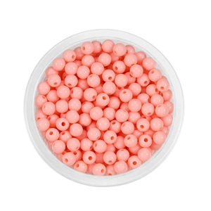Detail of 6mm round acrylic spacer beads in light pink stored in a clear plastic container