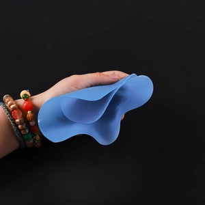Close-up of flexible blue silicone mat showing extreme soft texture for DIY jewelry making