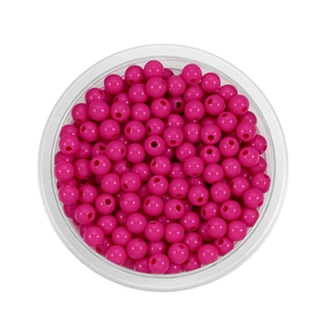 Overhead macro of 6mm vibrant pink acrylic spacer beads for DIY jewelry making