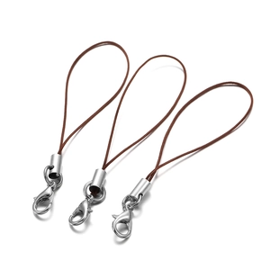 Close-up of brown nylon cord lanyards with silver lobster clasps for DIY jewelry making