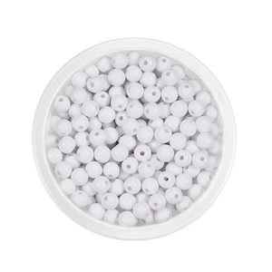 Detail of 6mm white acrylic spacer beads with holes in a round container for DIY crafts