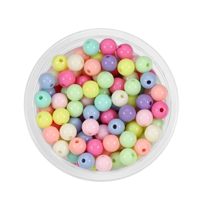 Macro shot of 6mm colorful acrylic round spacer beads for DIY jewelry making in a tray