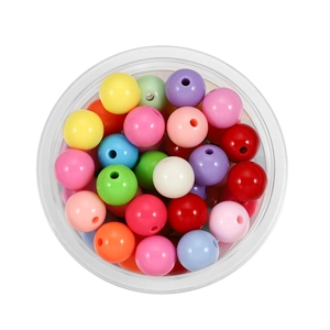 Macro shot of 6mm colorful acrylic beads for DIY jewelry making in a round clear box
