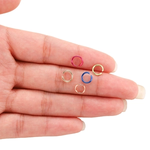 Handheld view of colorful aluminum open jump rings for DIY jewelry making accessories