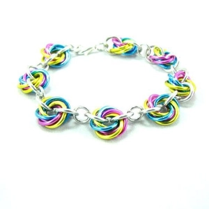 Detailed interlocking colorful aluminum jump rings forming a creative heart-knot bracelet