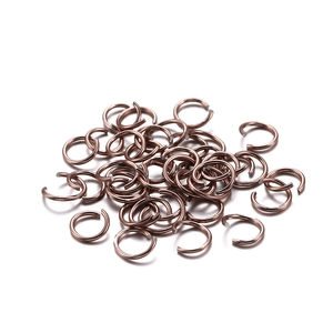 Macro shot of rose gold open jump rings for DIY jewelry making and bracelet repairs