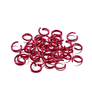 Close-up of vibrant red aluminum open jump rings for DIY jewelry making and linking